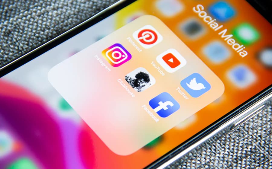 Smartphone displaying a folder of social media apps on its home screen