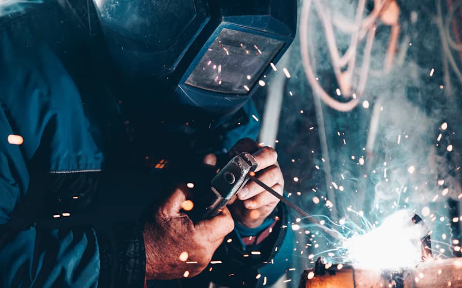 Welder in protective gear working with sparks flying, representing hands-on hazard exposure